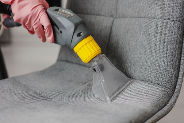 A man cleaning a chair